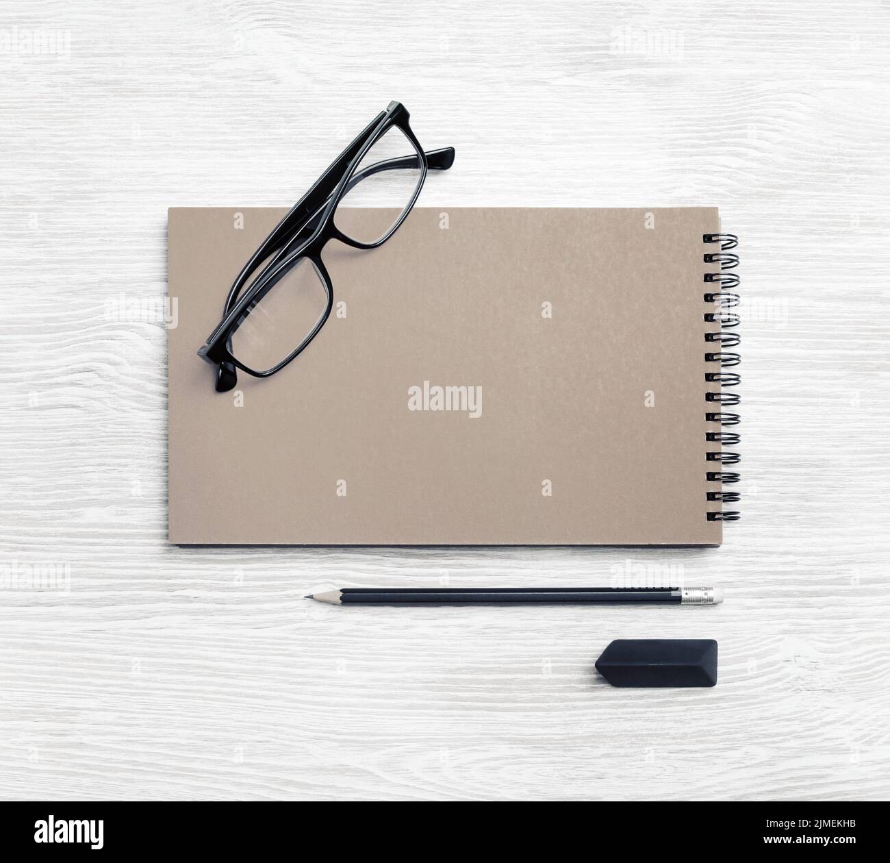 Kraft notebook, glasses, pencil, eraser Stock Photo