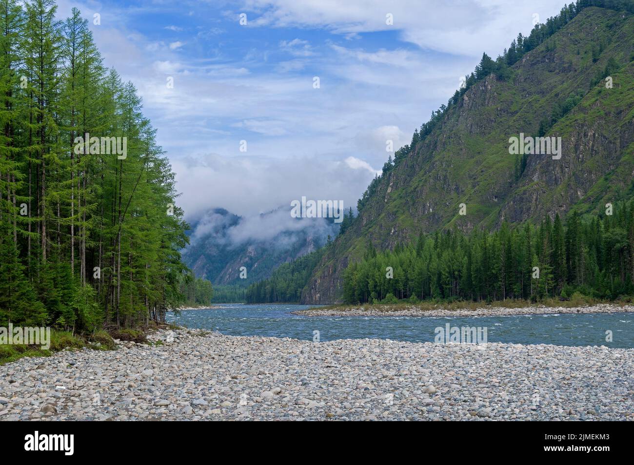 Low clouds in a mountain gorge over the river. Stock Photo