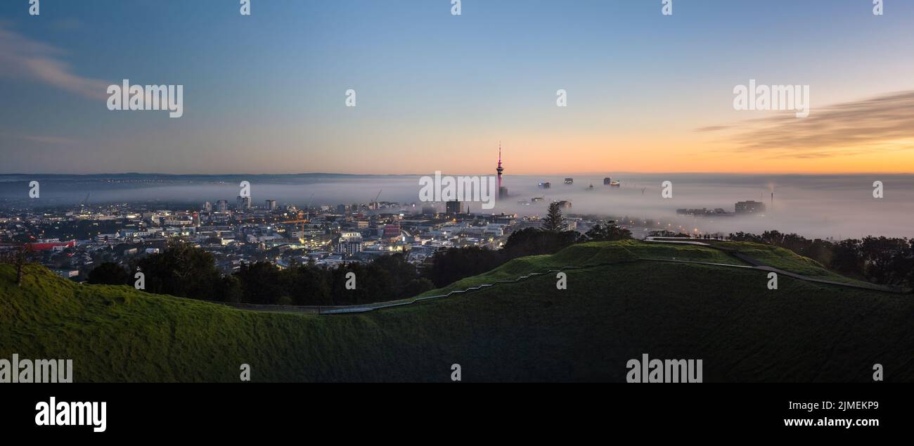 Panoramic view of Sky Tower and Auckland city in the fog, from Mount Eden summit. Stock Photo