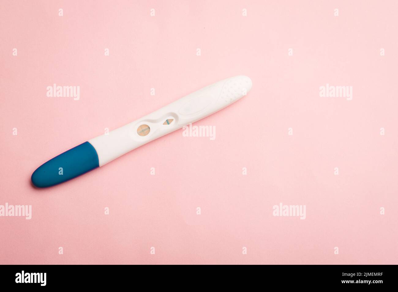 Pregnancy test on a pink background . Positive test. Pregnancy copy