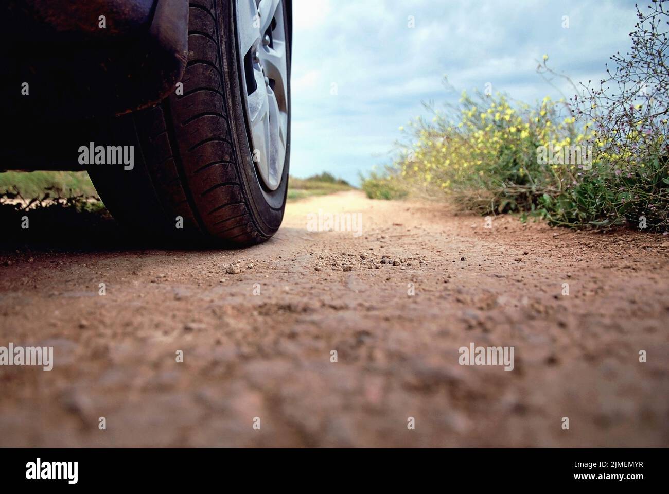 Car wheel on the road, low angle shot, road trip and adventuring Stock Photo