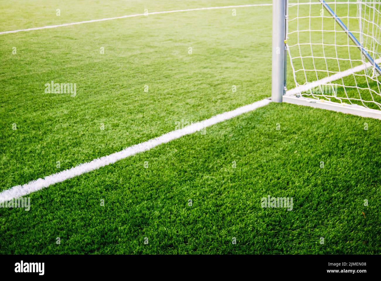 Corner of goalposts on green grass of soccer field, no people Stock Photo