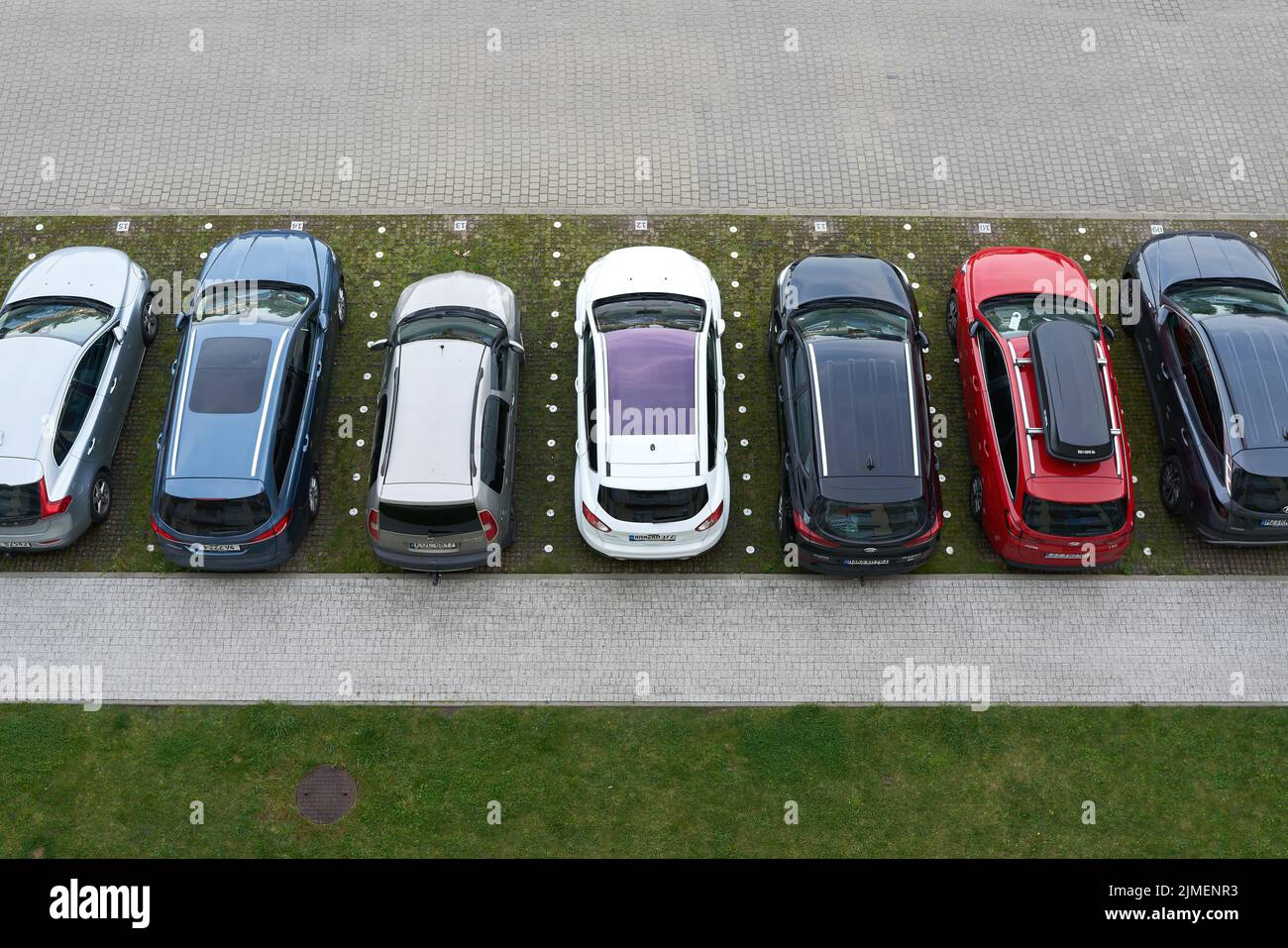 Parking lot with cars in front of a hotel in the city of Kolobrzeg in Poland from bird's eye view Stock Photo
