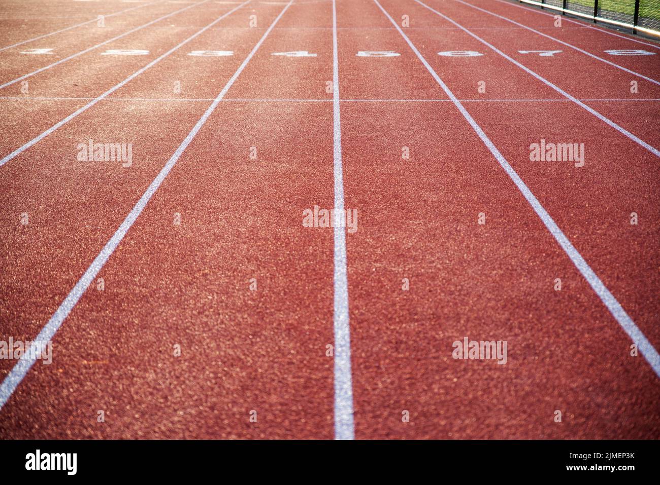 Running track with numbered lanes and crisp lines. Stock Photo