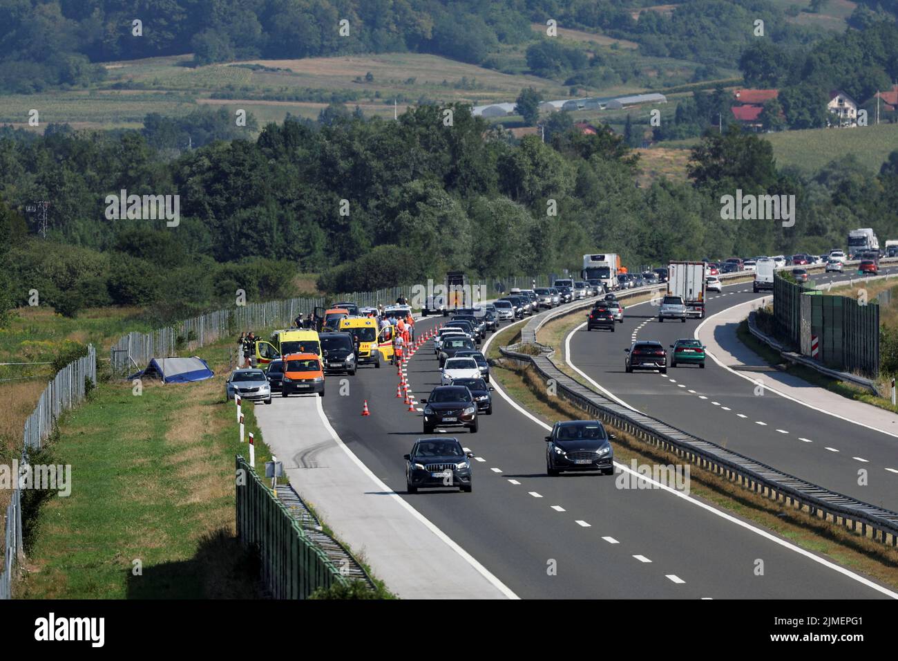 Rescuers work at the scene where a bus with Polish licence plates slipped off a road near Varazdin, northwestern Croatia, August 6, 2022. REUTERS/Antonio Bronic Stock Photo