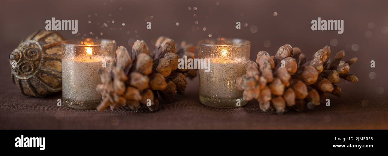 Candles pine cones and christmas decoratoin border Stock Photo