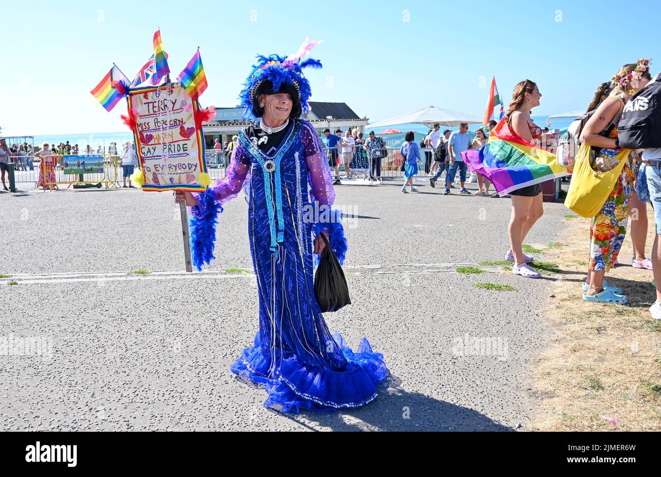 Brighton UK 6th August 2022 - Terry known as miss Popcorn at the  Brighton and Hove Pride Parade on a beautiful hot sunny day. With good weather forecast large crowds are expected to attend the UK's biggest LGBTQ Pride festival in Brighton over the weekend : Credit Simon Dack / Alamy Live News Stock Photo