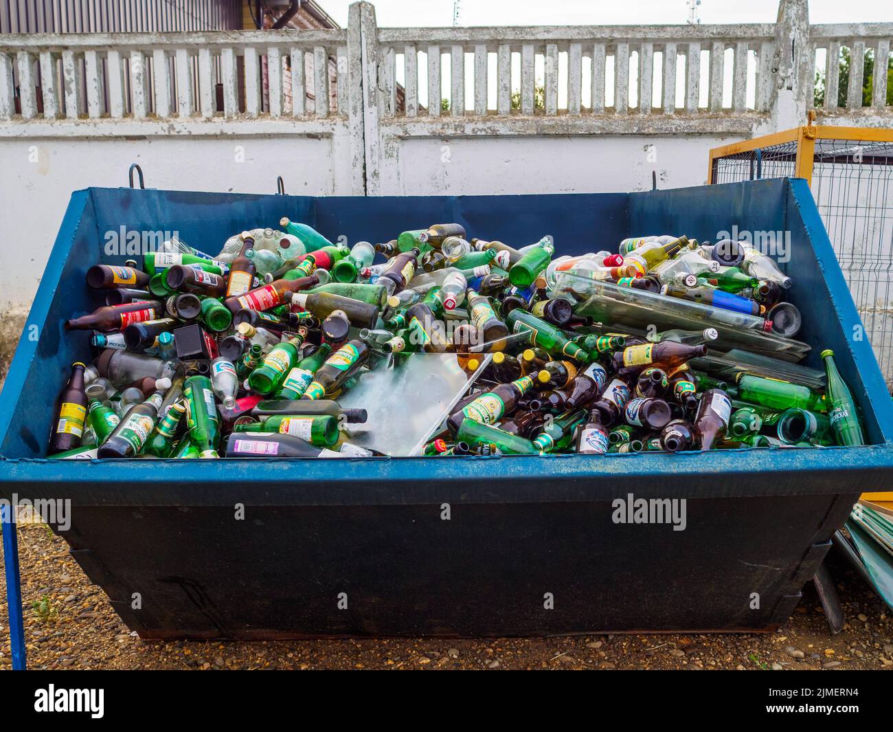 A large garbage bin filled with used glass bottles Stock Photo Alamy