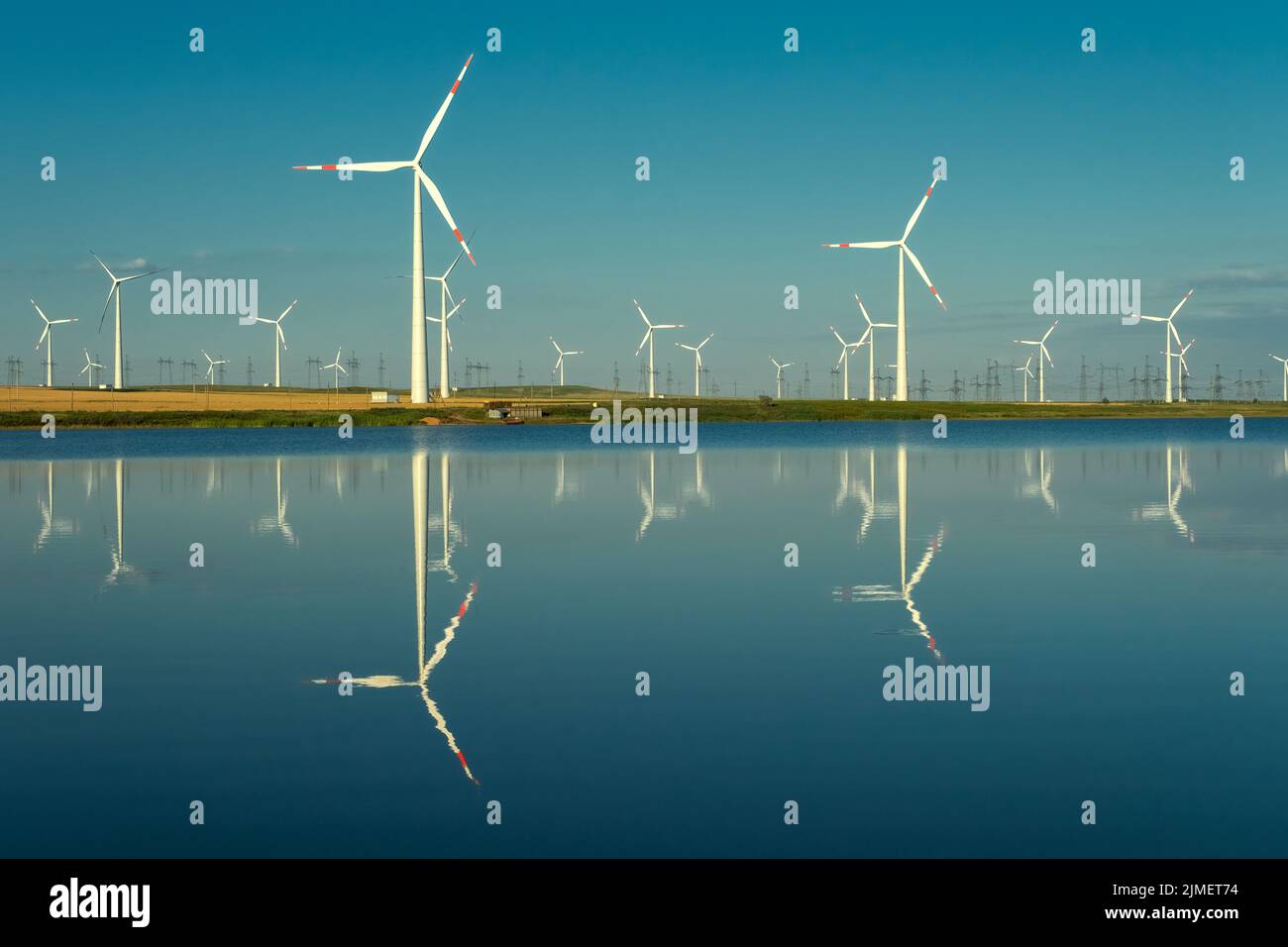 Windmills turbines with water reflection Stock Photo