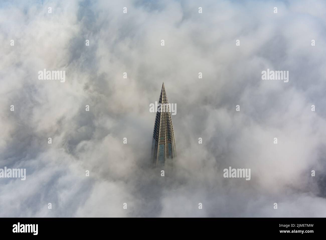 Russia, St. Petersburg, 14 October 2021: The top of the tallest skyscraper in Europe above the clouds, the building of the Gazpr Stock Photo
