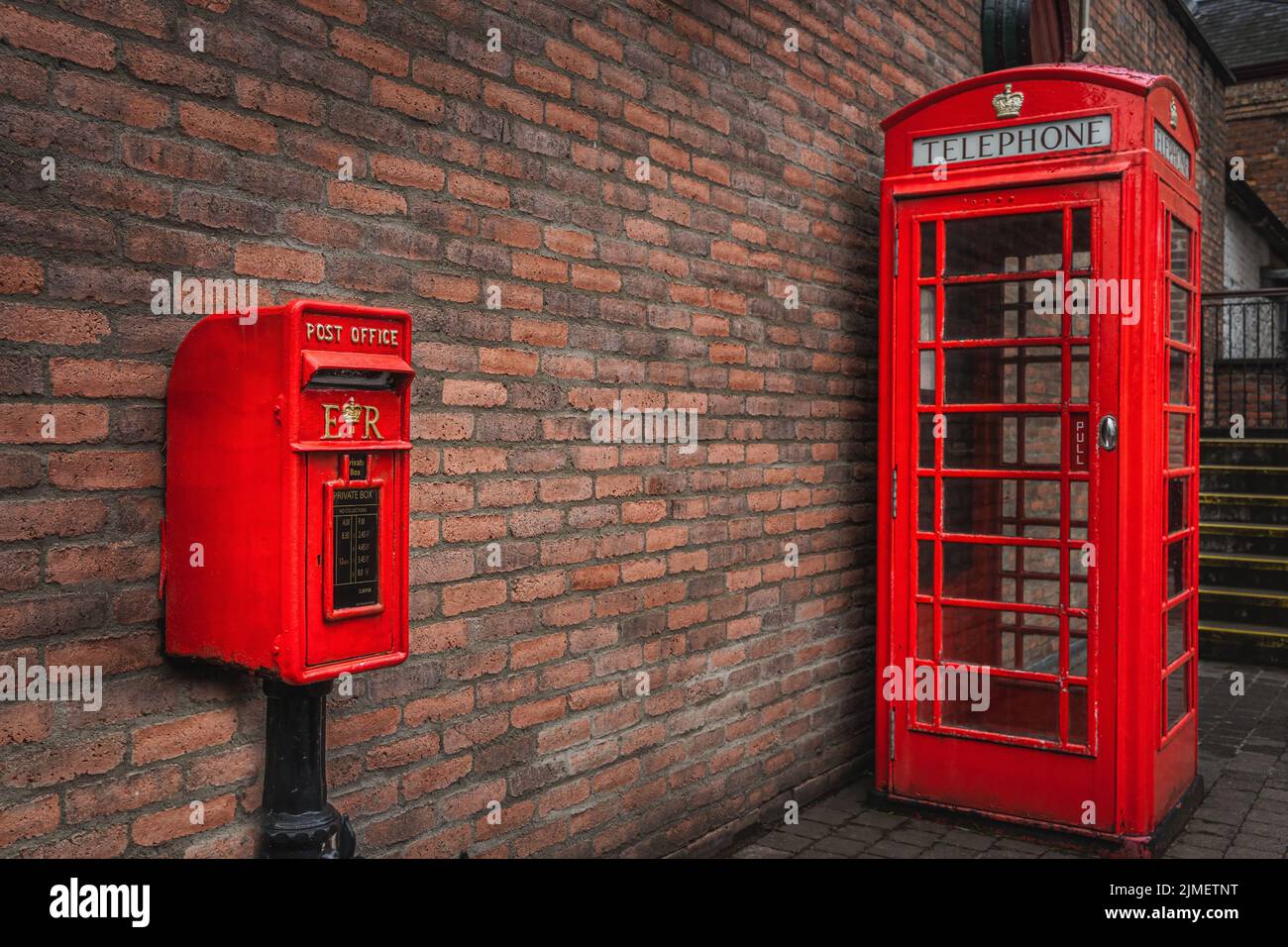 The traditional British public red mailbox and telephone kiosk or booth Stock Photo