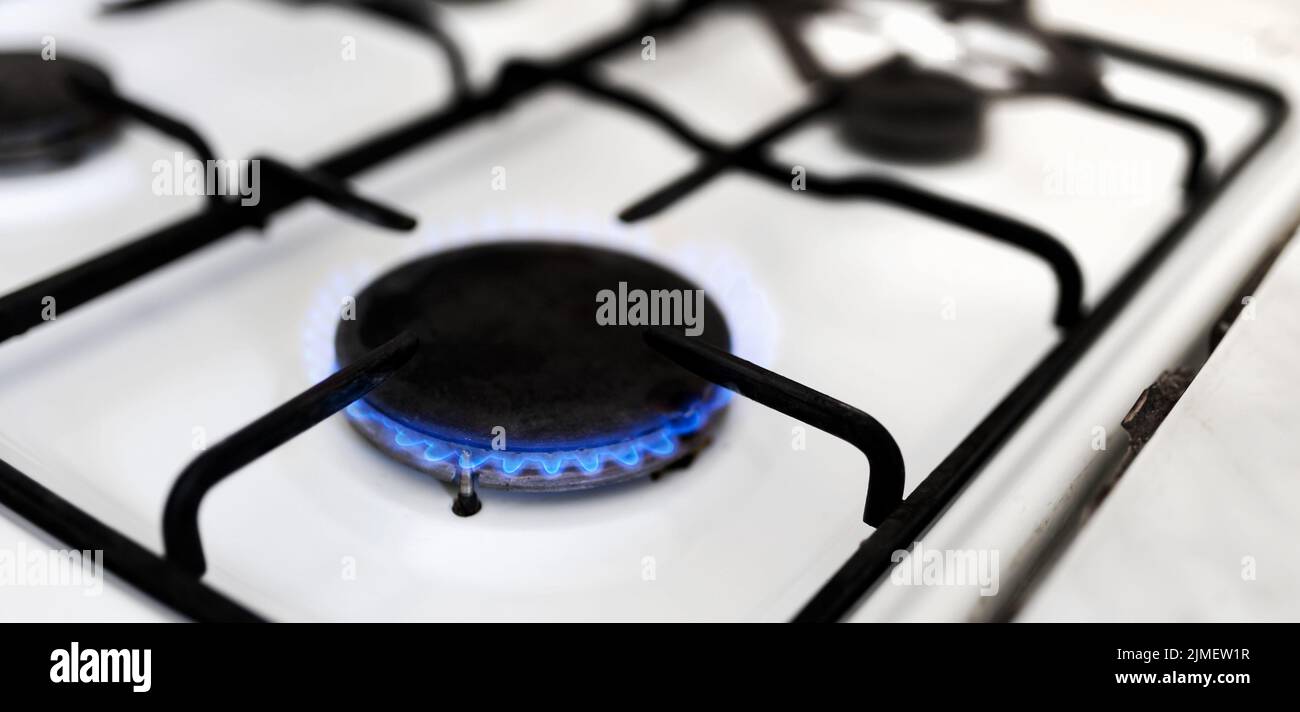 Old gas stove with blue flame. Energy crisis, price increase banner Stock Photo Alamy