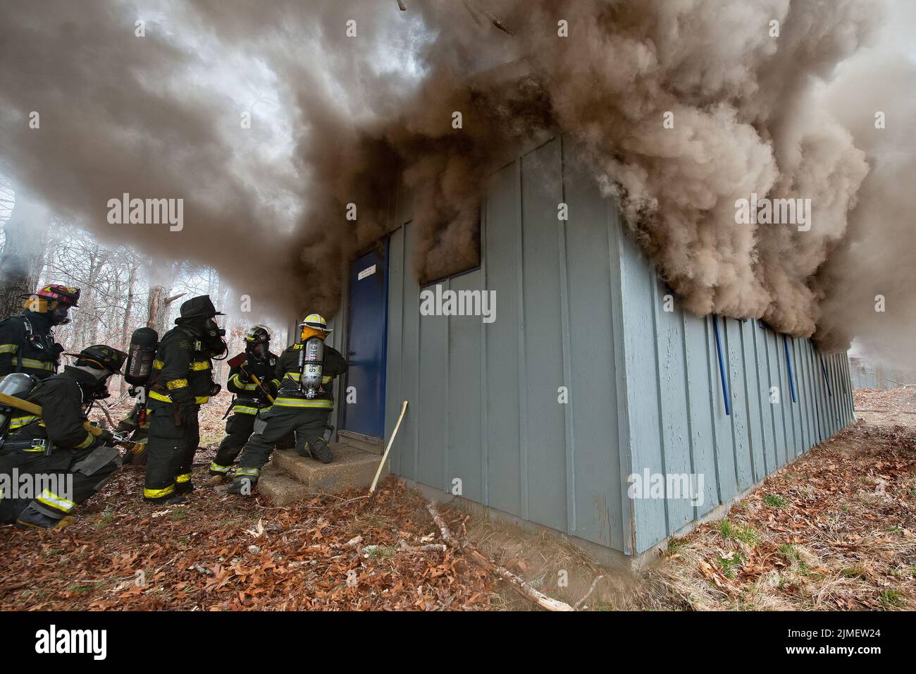 Firefighters prepare to make entry into a building as members of the East Hampton Fire Department, along with members of the Springs Fire Department a Stock Photo
