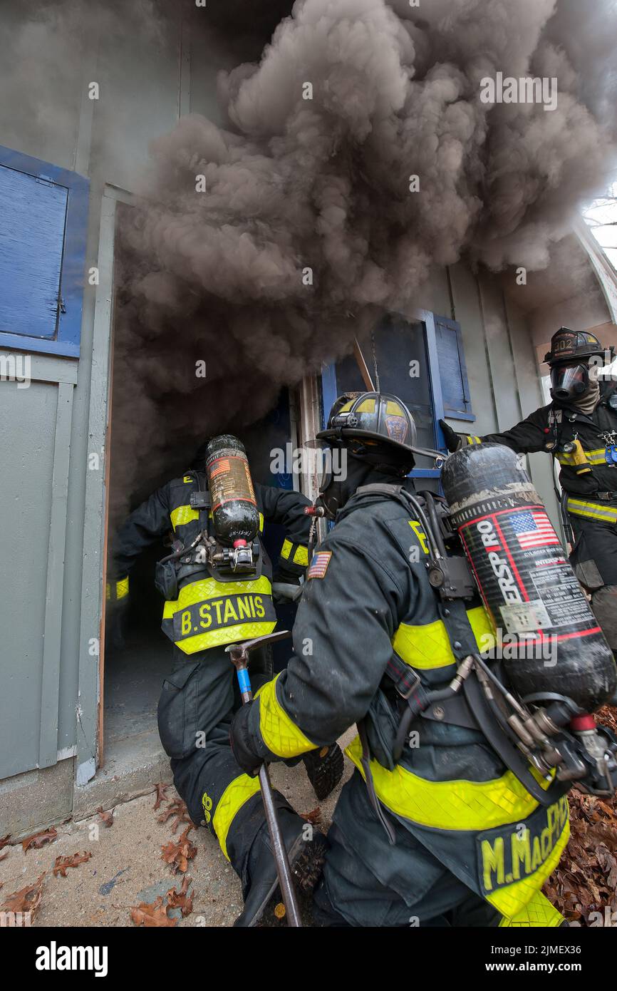 Firefighters make entry into a building as members of the East Hampton