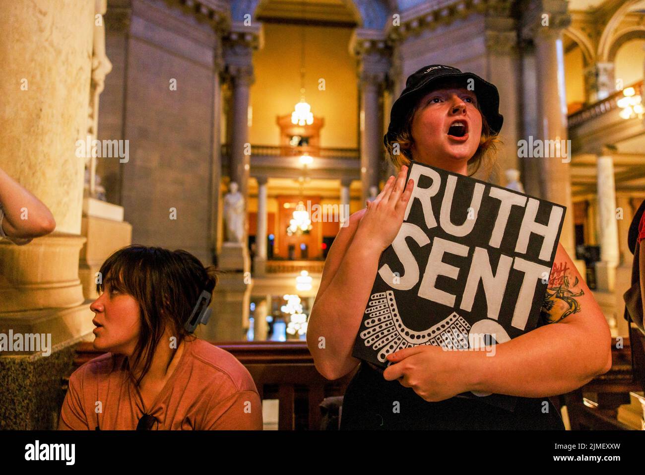 Abortion rights activists protest as the Indiana Senate debates before voting to ban abortion during a special session in Indianapolis. The legislature held a special session to ban abortion rights in the wake of the U.S. Supreme Court ruling overturning Roe v. Wade in June. Holcomb signed the bill into law. Stock Photo