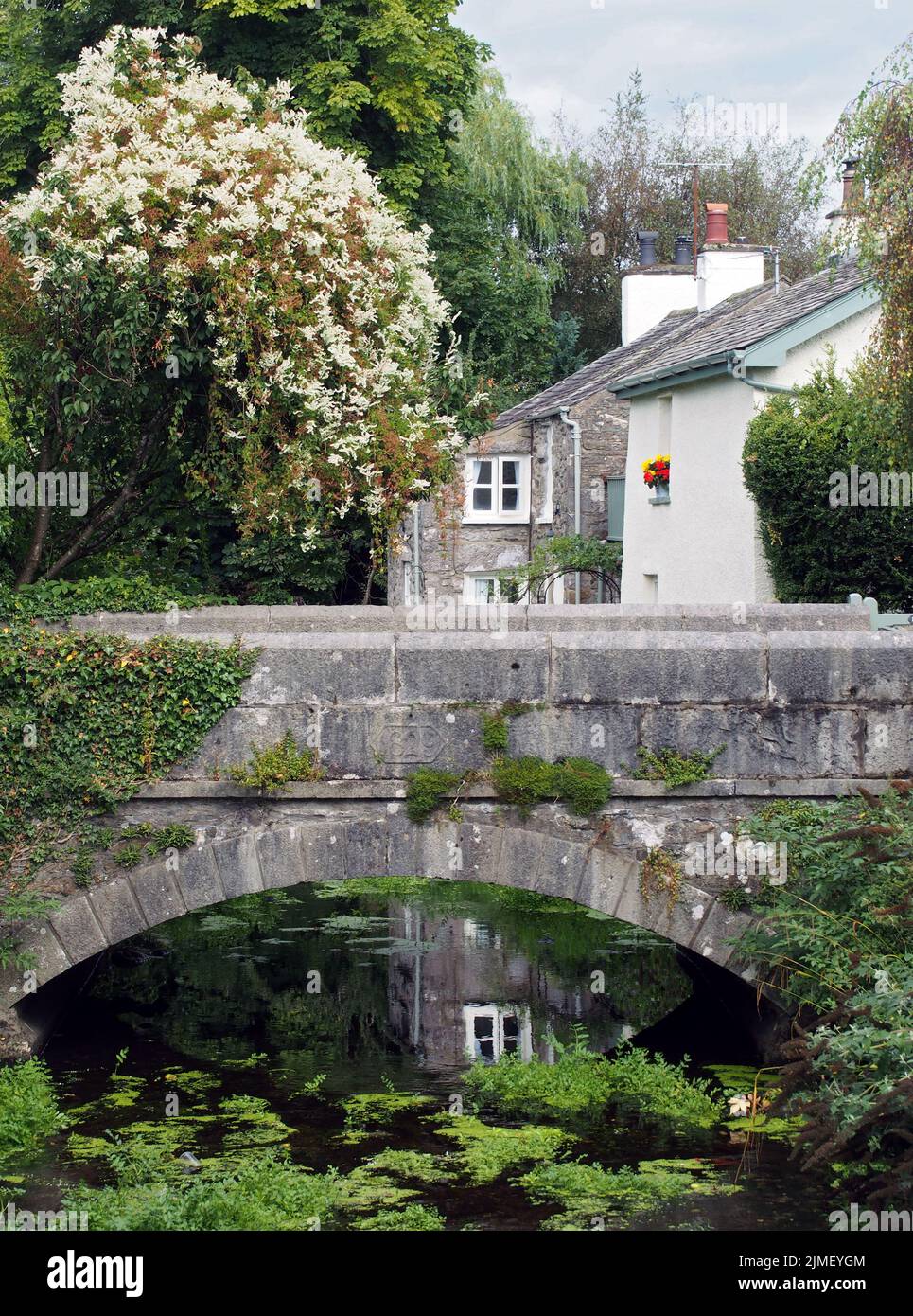 View of the bridge crossing the river with surrounding village houses in cartmel, cumbria Stock Photo