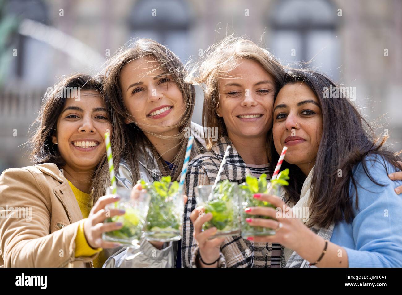 Muti ethnic group of female friends having fun drinking cocktails outdoor in the city in bar restaurant Stock Photo