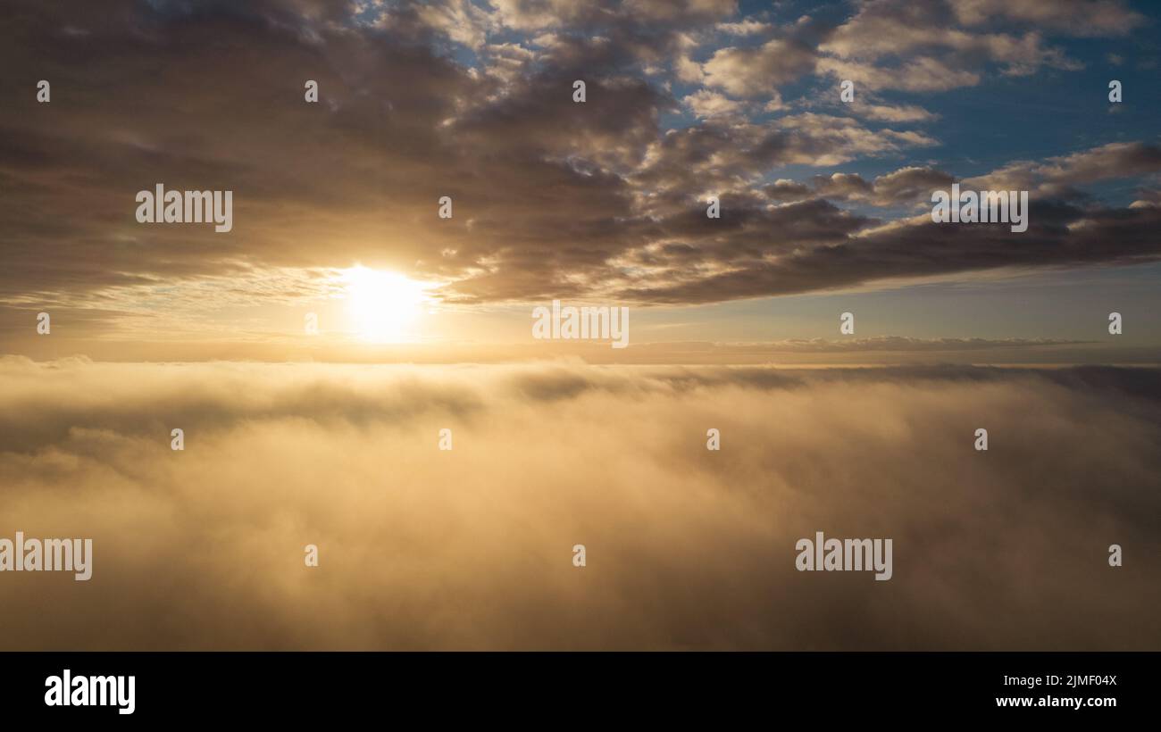 Aerial View. Flying in fog, fly in mist over the early morning clouds