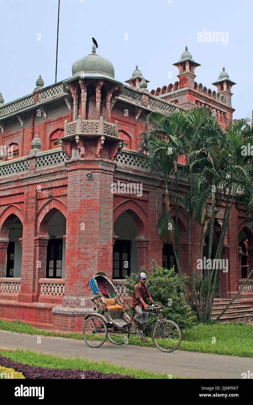 Dhaka, Bangladesh - September 17, 2007: Rickshaw driver waits for customers at the former residence of Lord Curzon - currently part of the University Stock Photo
