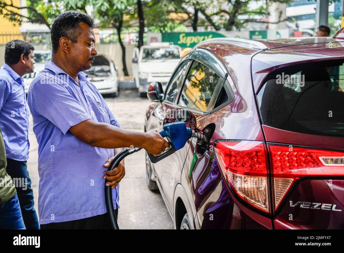 A pump attendant refuels a car at a Petrol station in Dhaka. The government has increased fuel oil prices by 42.5% to 51.6%, highest in 20 years, dealing a big blow to people already overwhelmed by skyrocketing prices of essential goods amid record inflation. The Energy and Mineral Resources Division on Friday night hiked diesel and kerosene prices by Tk34 per litre to Tk114 and octane and petrol prices by Tk46 per litre to Tk135. The government announced the hike at a time when oil prices in the international market are on a downward trend. Brent crude price on Friday was $95.50/barrel. It ha Stock Photo