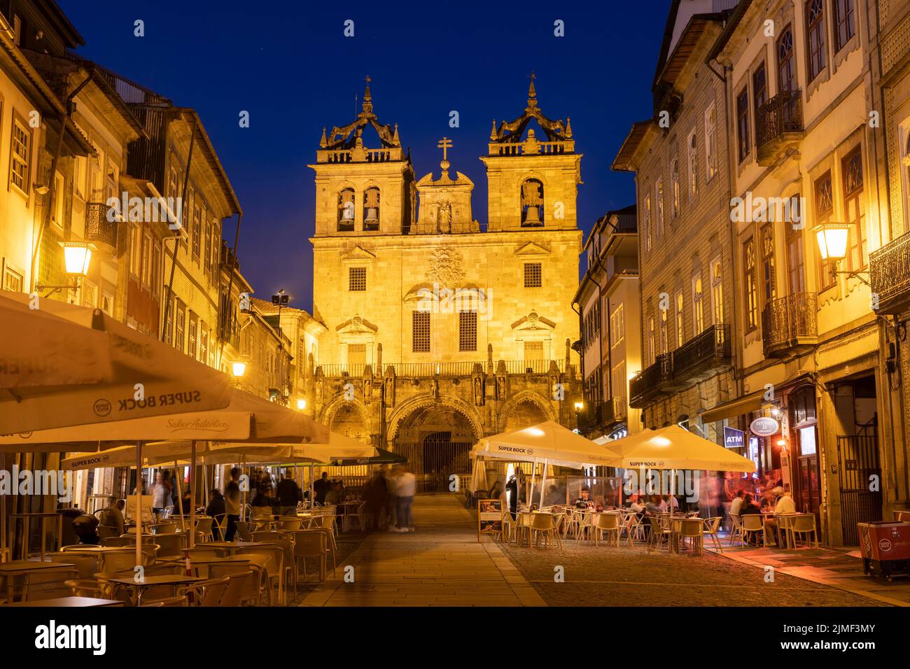 Braga, PORTUGAL - June 25, 2022: People in Restaurants in front of the cathedral of Braga at blue hour. Stock Photo