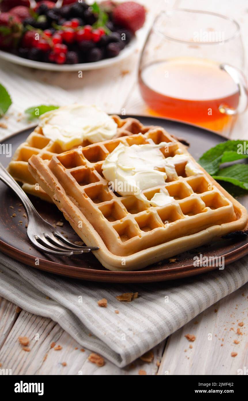 Belgian waffles served with butter and honey Stock Photo