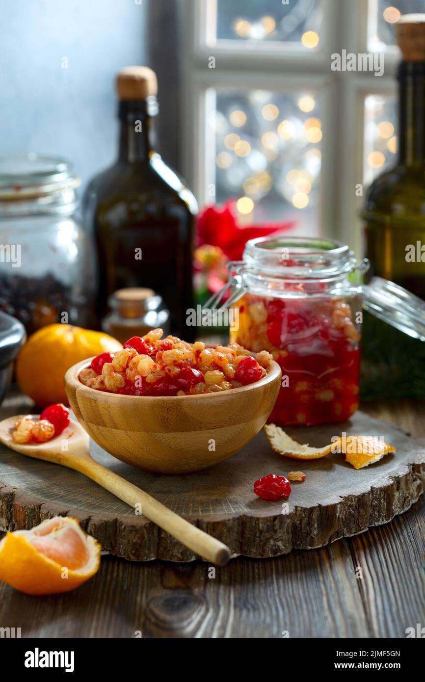 Mixed dried fruits and raisins soaked in spices in rum. Stock Photo