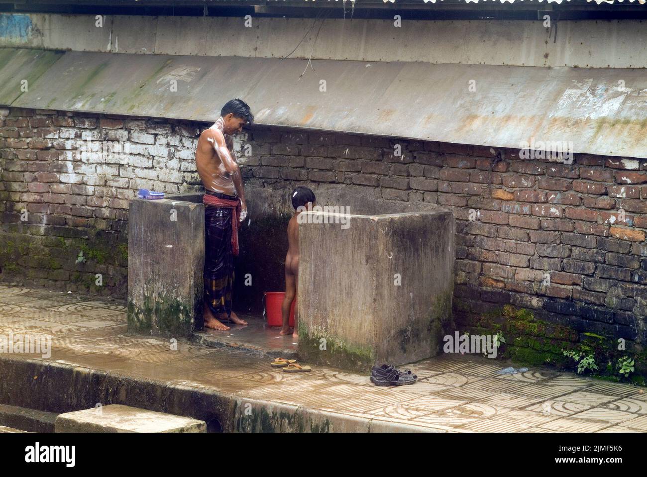 Dhaka, Bangladesh - September 17, 2007: Unidentified people on public washing place used by the poorer population Stock Photo