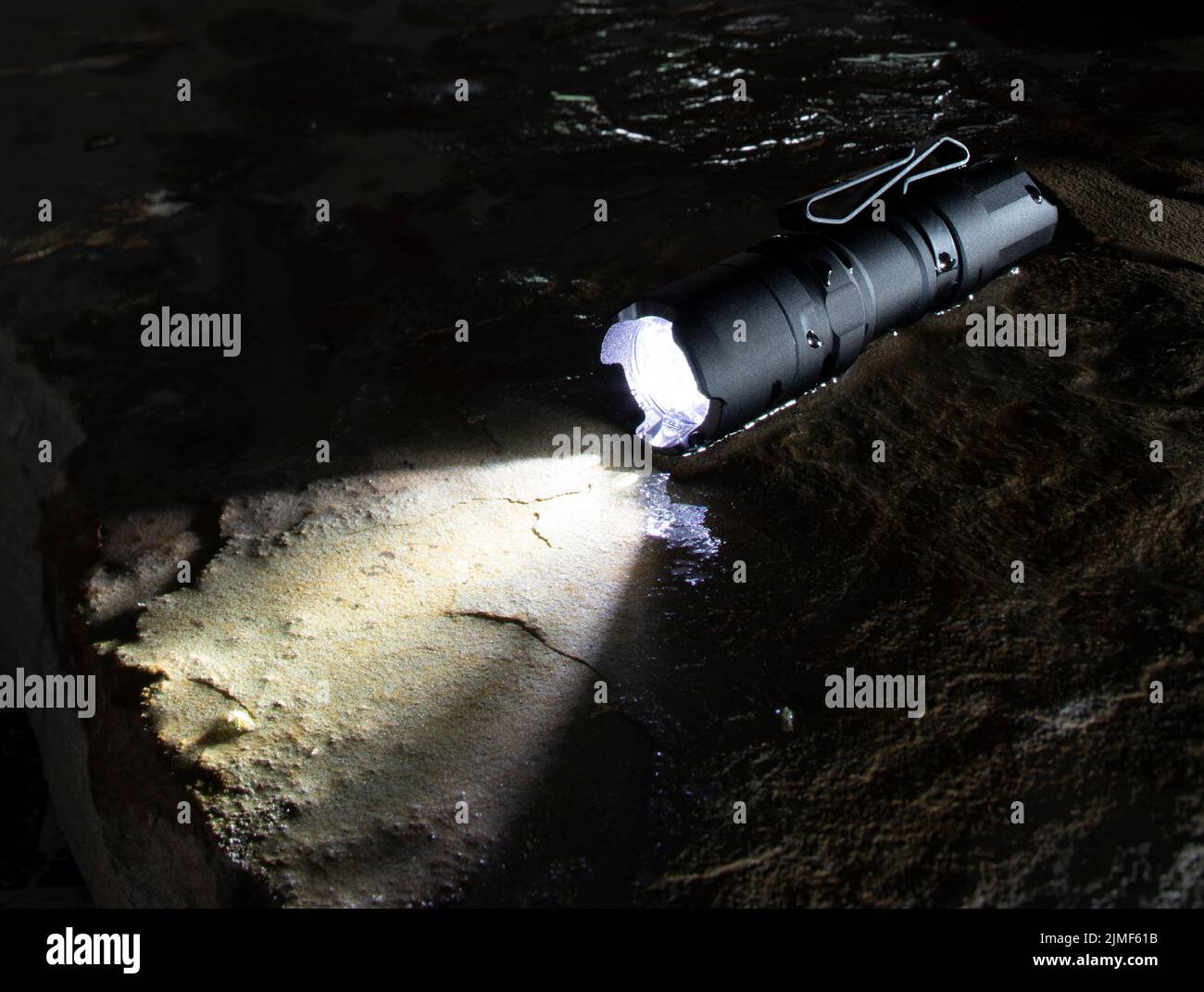 Flashlight operating well despite wet conditions with room for copy Stock Photo