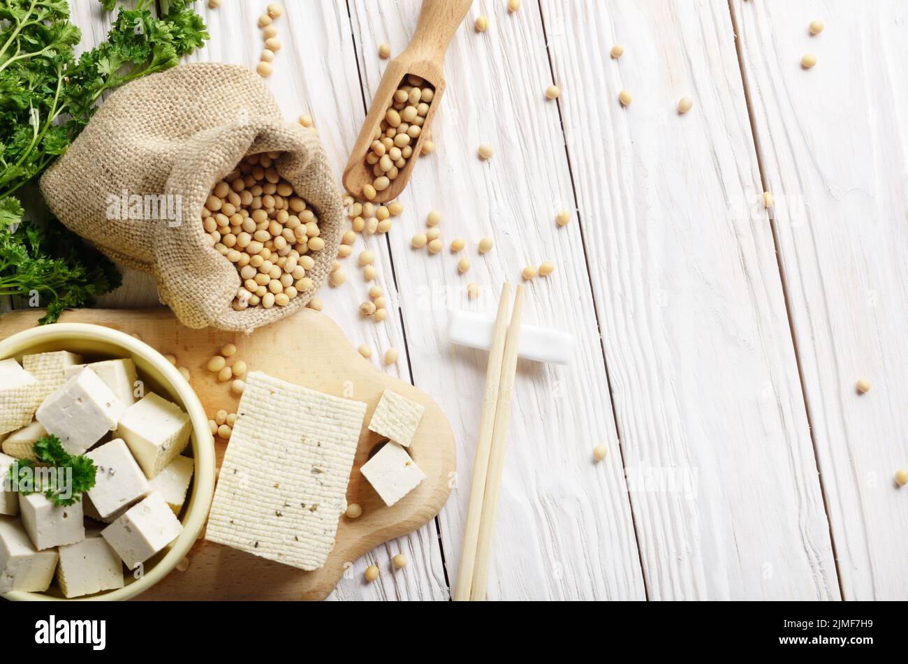 Soy Bean curd tofu in clay bowl and in hemp sack on white wooden