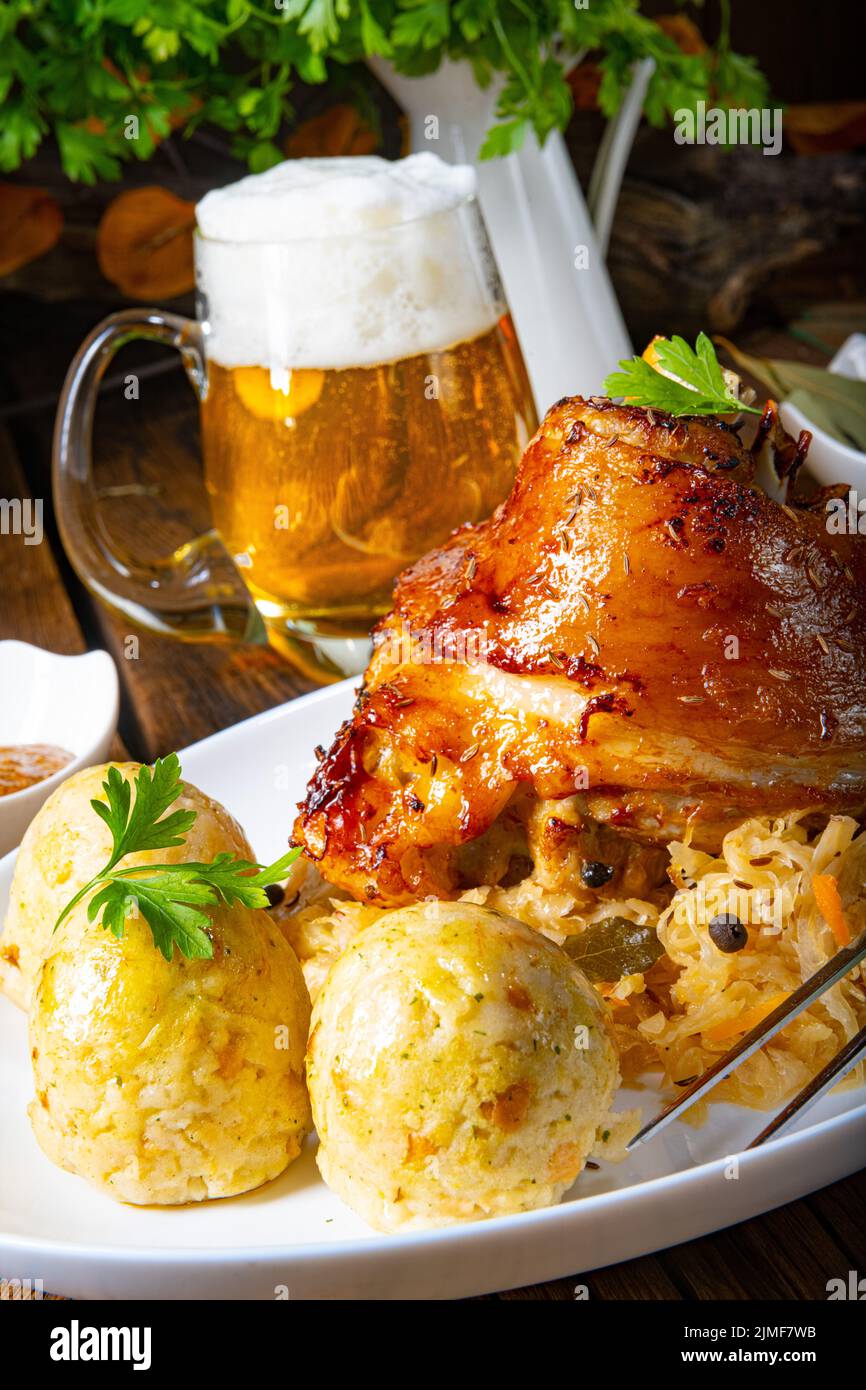 Pork knuckle with sauerkraut and sweet mustard Stock Photo Alamy