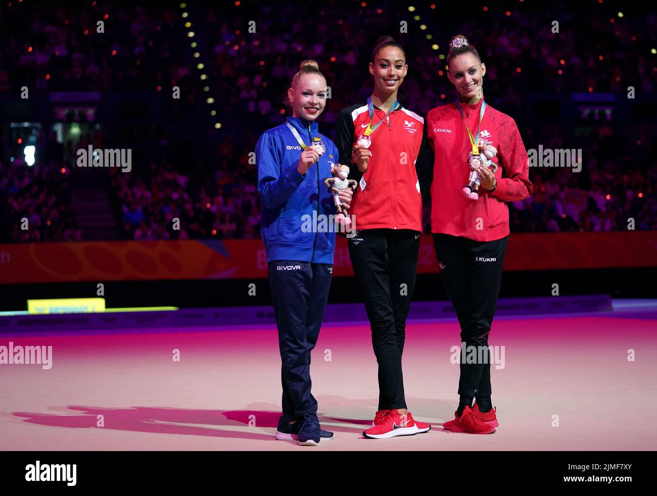 Cyprus' Anna Sokolova, silver, Wales' Gemma Frizelle, gold and Canada's Carmel Kallemaa, bronze, after the Rhythmic Gymnastics Hoop Final at Arena Birmingham on day nine of the 2022 Commonwealth Games in Birmingham. Picture date: Saturday August 6, 2022. Stock Photo