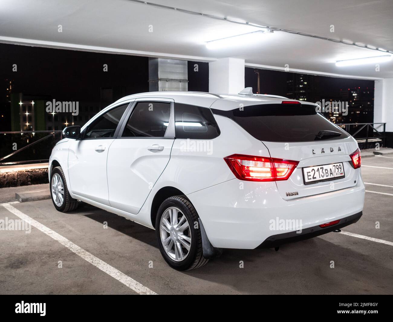 Rear view of a white car Lada Vesta SW in a multi-storey parking lot Stock Photo