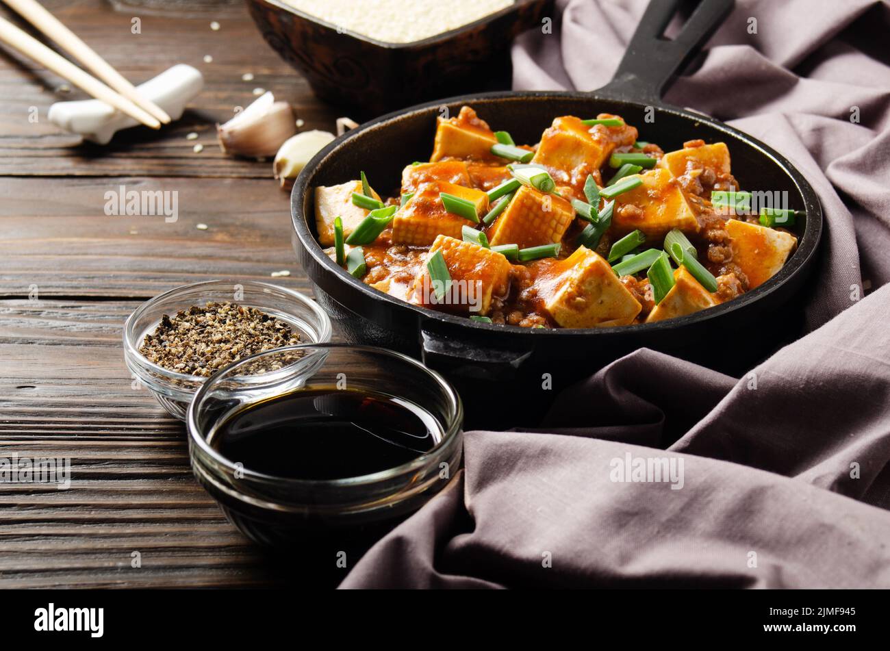 Mapo tofu in cast iron skillet with pork chopped chives soy sauce