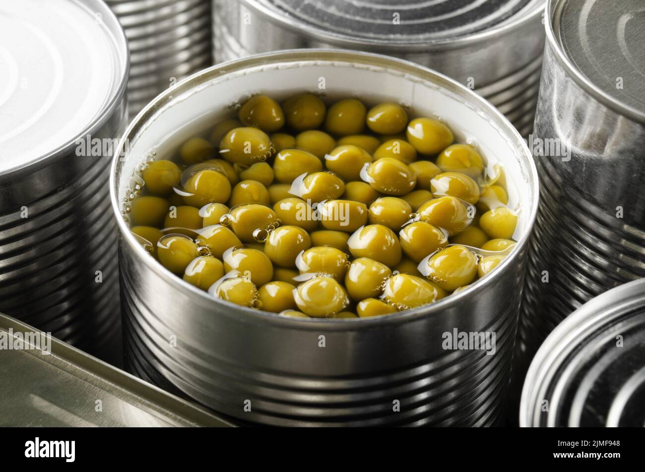 Canned green peas in just opened tin can. Nonperishable food Stock