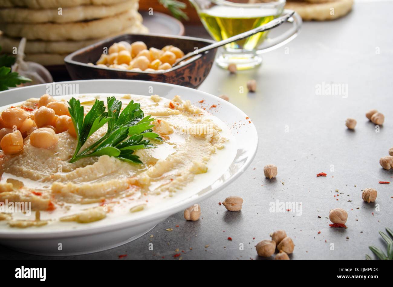 Low angle view at Hummus topped with chickpeas, olive oil and green