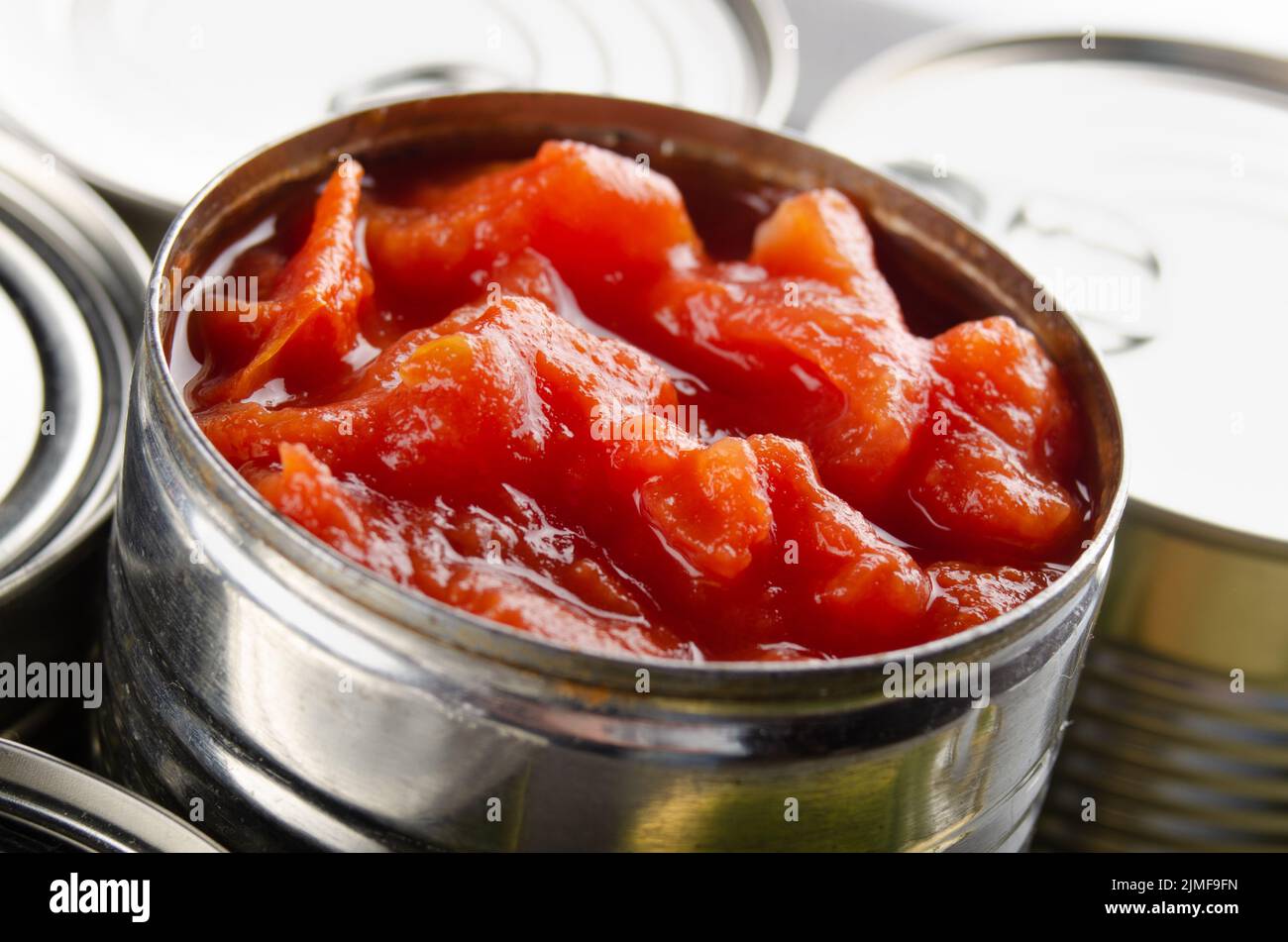 Canned sliced tomatoes in just opened tin can. Nonperishable food