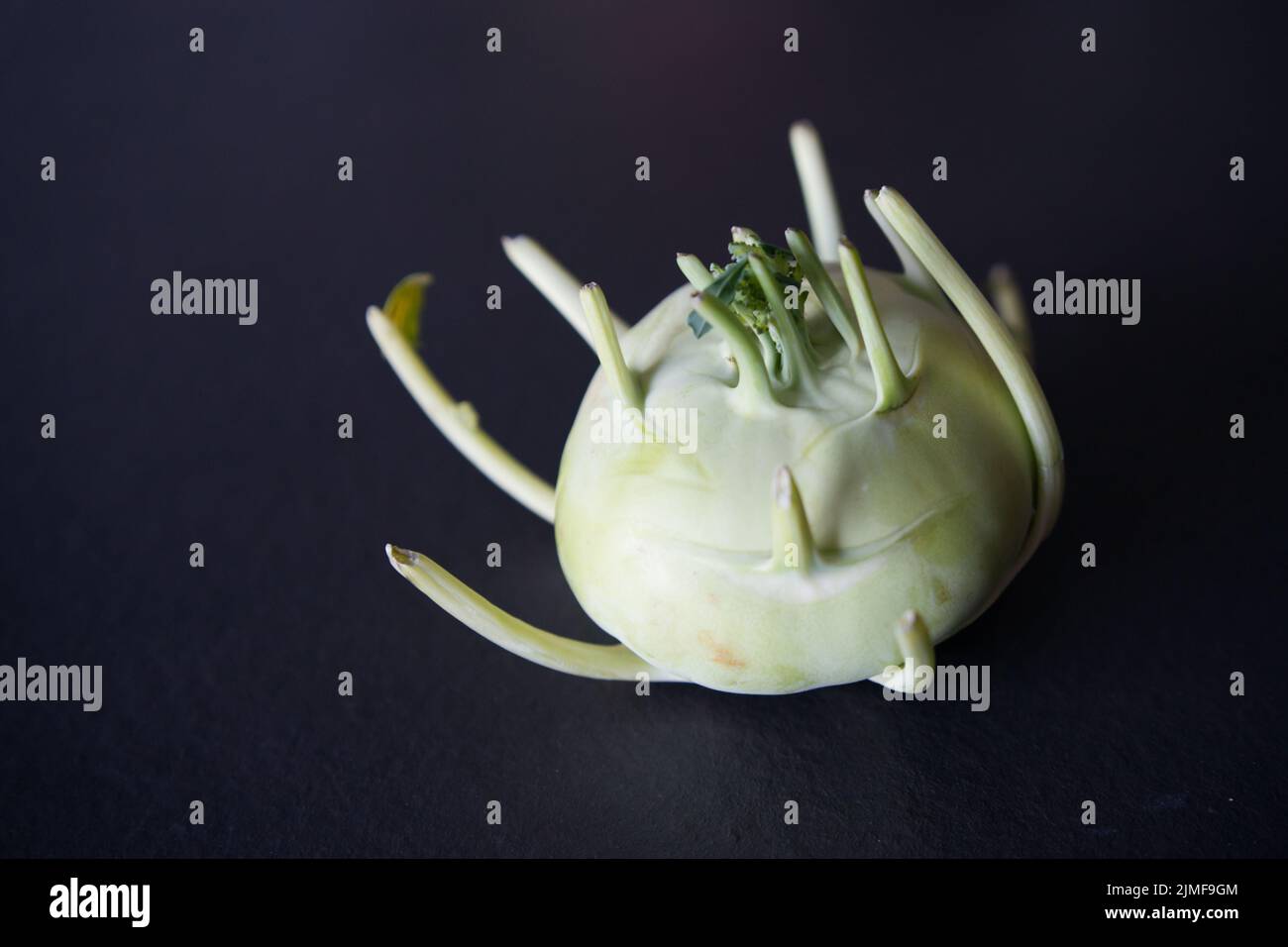 German turnip or kohlrabi, a strange vegetable with black background Stock Photo