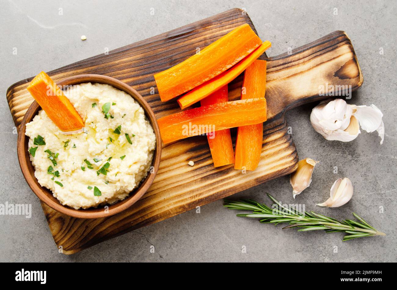 Flat lay view at vegetable Hummus dip dish topped with olive oil served