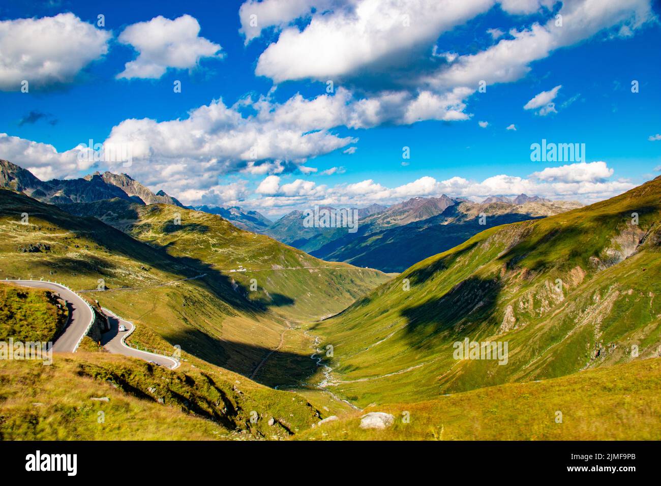The steep and winding Furka Pass leads across valleys in the Alps connecting Central Switzerland with the Valais and the Bernese Oberland - Europe Stock Photo