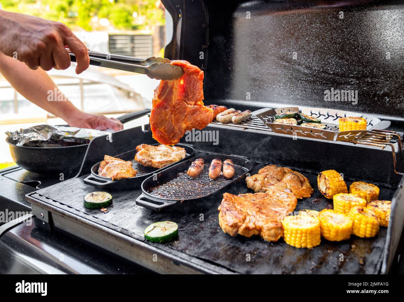 Beef steak and grill barbecue outdoors on the backyard. Bbq party. Stock Photo