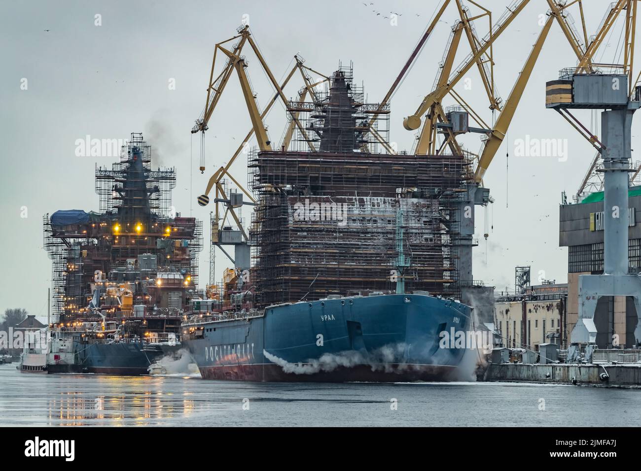 Russia, St. Petersburg, 05 February 2021: The construction of nuclear icebreakers, cranes of of the Baltic shipyard in a frosty Stock Photo