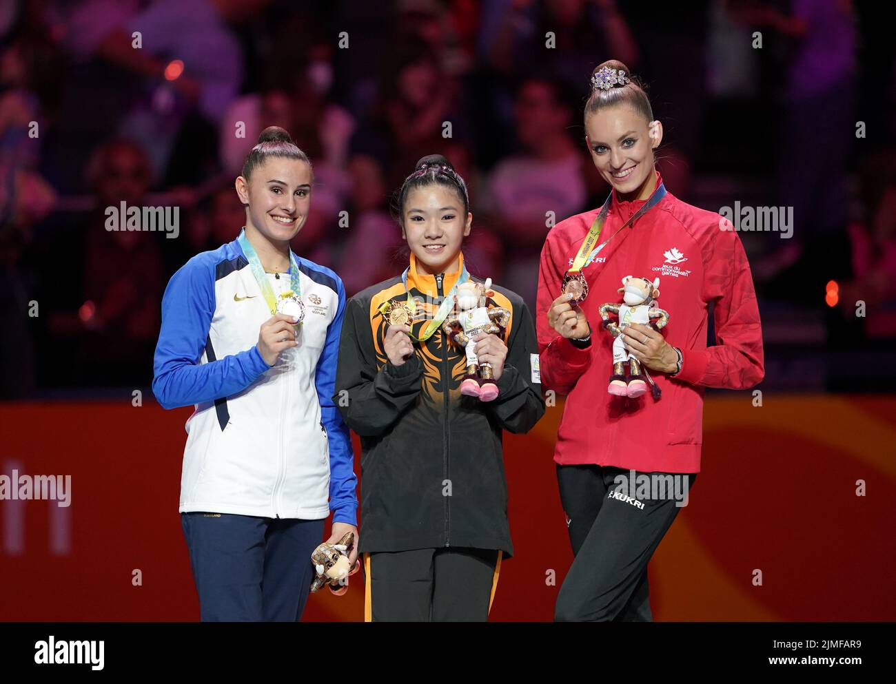 Scotland's Louise Christie, silver, Malaysia's Joe Ee Ng, gold and Canada's Carmel Kallemaa, silver, after the Rhythmic Gymnastics Ribbon Final at Arena Birmingham on day nine of the 2022 Commonwealth Games in Birmingham. Picture date: Saturday August 6, 2022. Stock Photo