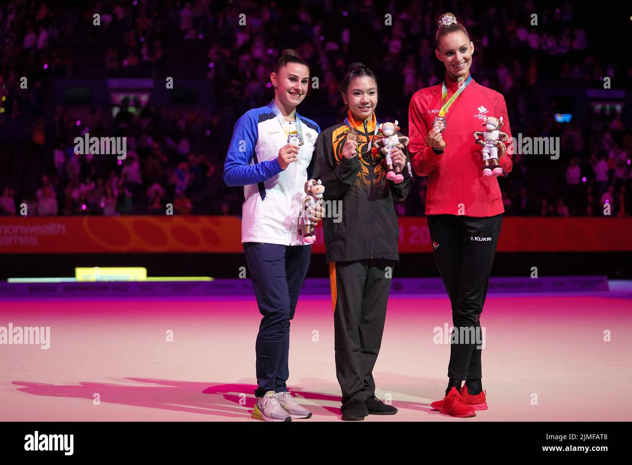 Scotland's Louise Christie, silver, Malaysia's Joe Ee Ng, gold and Canada's Carmel Kallemaa, silver, after the Rhythmic Gymnastics Ribbon Final at Arena Birmingham on day nine of the 2022 Commonwealth Games in Birmingham. Picture date: Saturday August 6, 2022. Stock Photo