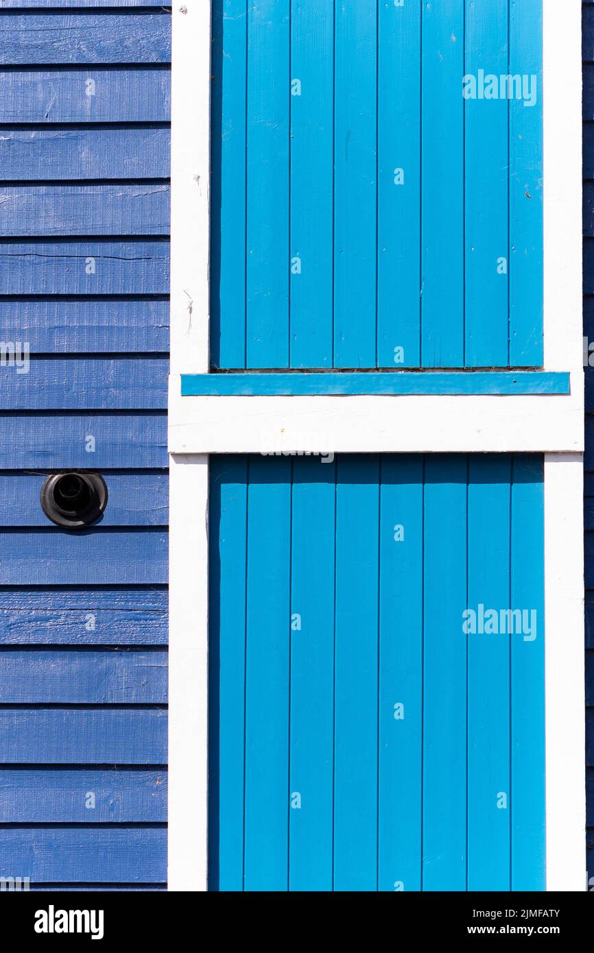 Close up of a wooden building painted in two shades of blue, Littlehampton, West Sussex, UK Stock Photo