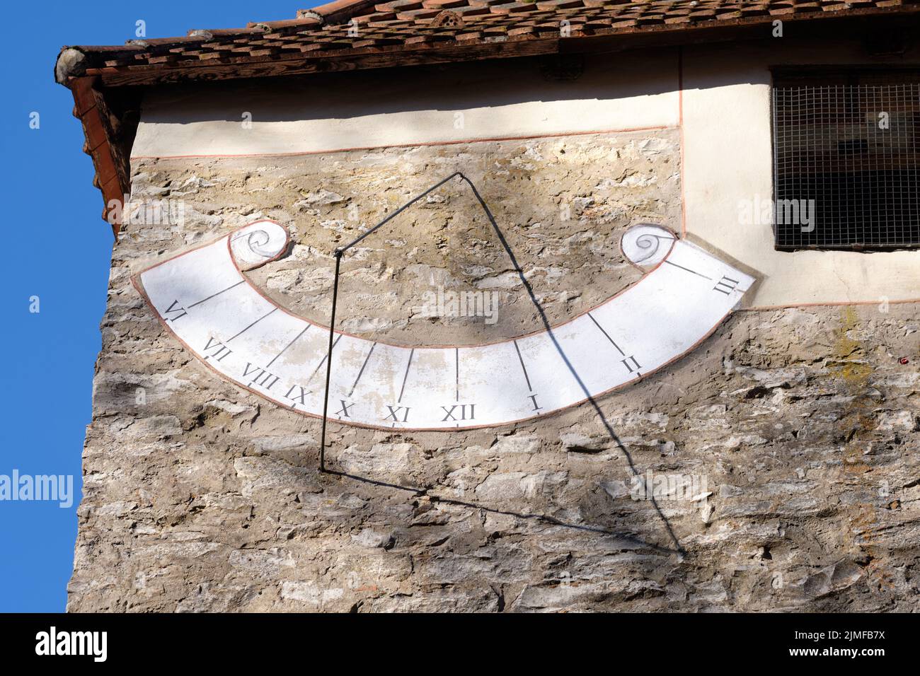 Close-up of the sundial on the wall of an old chapel on the Moritzberg in Germany on a sunny february day. Stock Photo