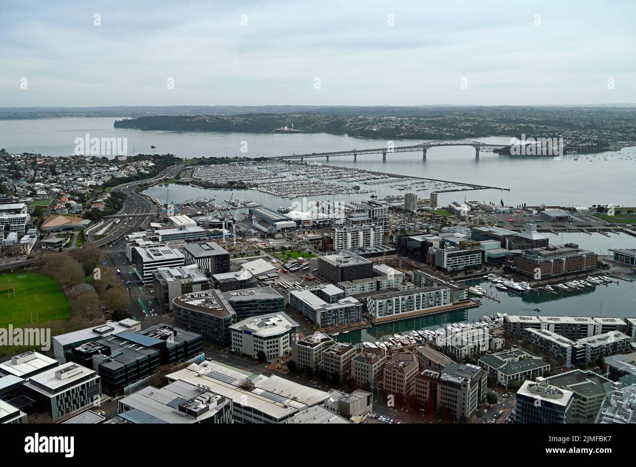 Panoramic aerial view of Auckland City &  Waitemata Harbour looking northwest to the  iconic Auckland Harbour Bridge in the distance. Stock Photo
