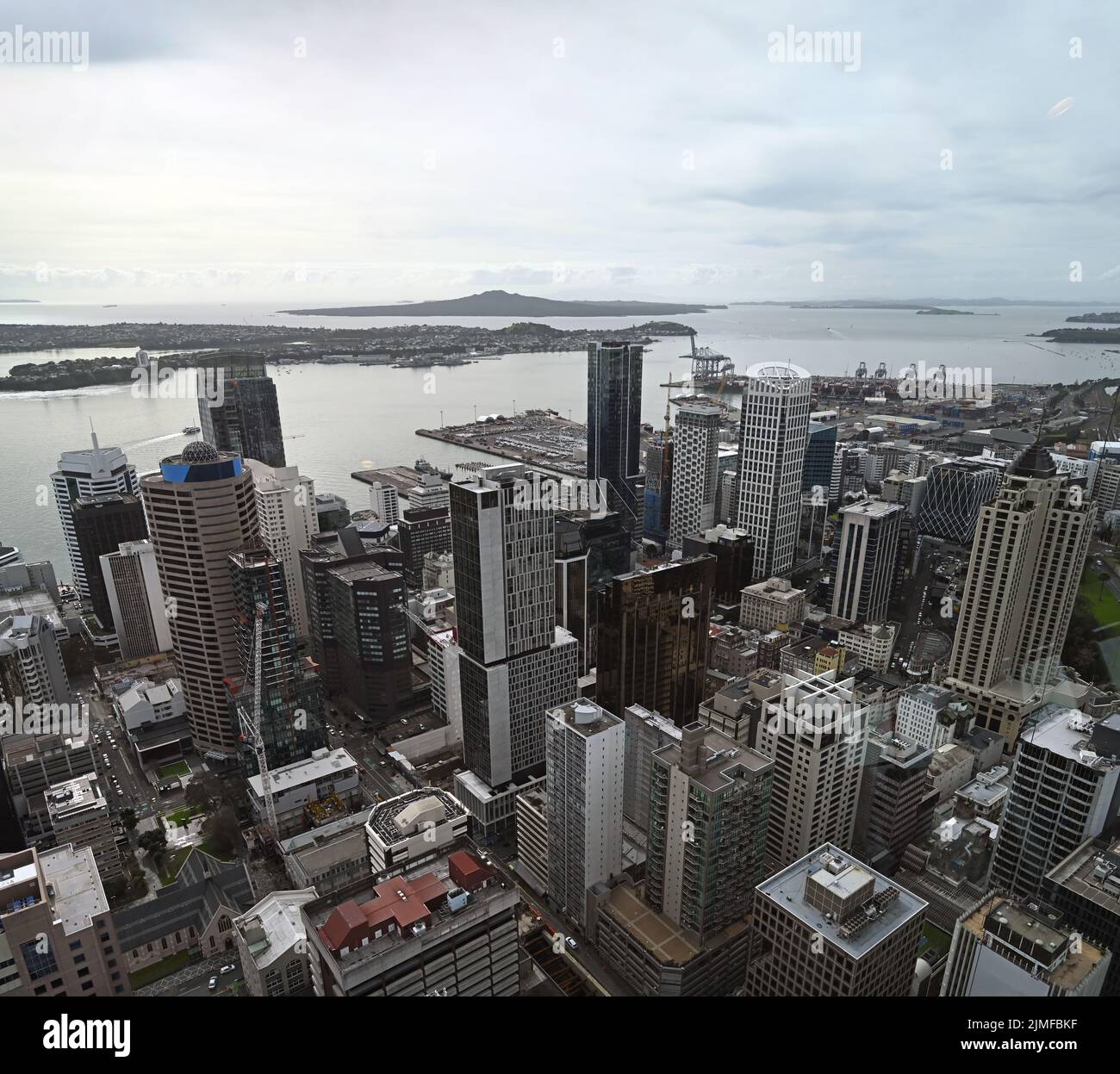 Auckland city & harbour vertical aerial panorama looking east to Rangitoto Island. In the foreground are the buildings of the CBD. Stock Photo