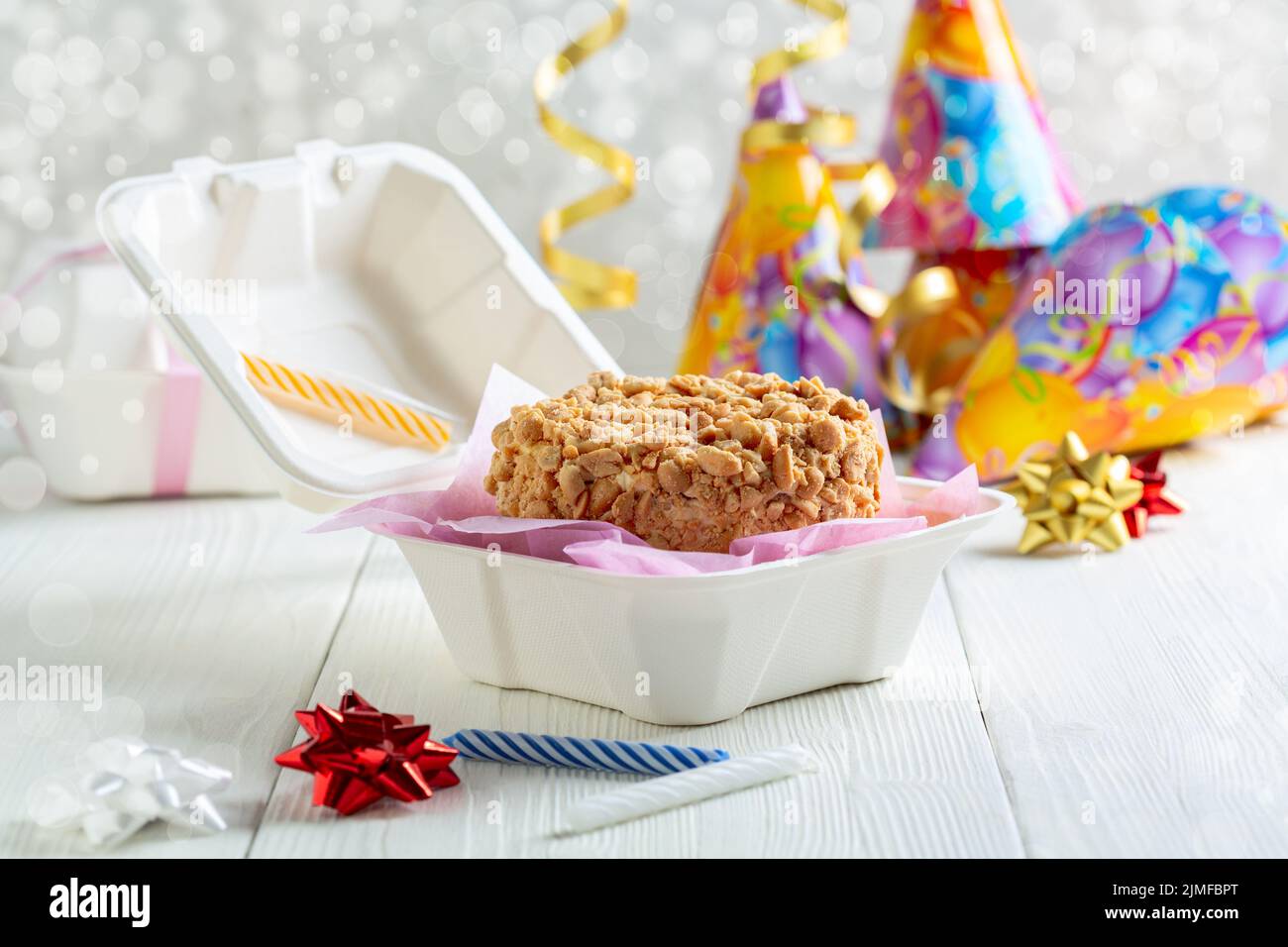 Small cake with peanuts in a box. Stock Photo