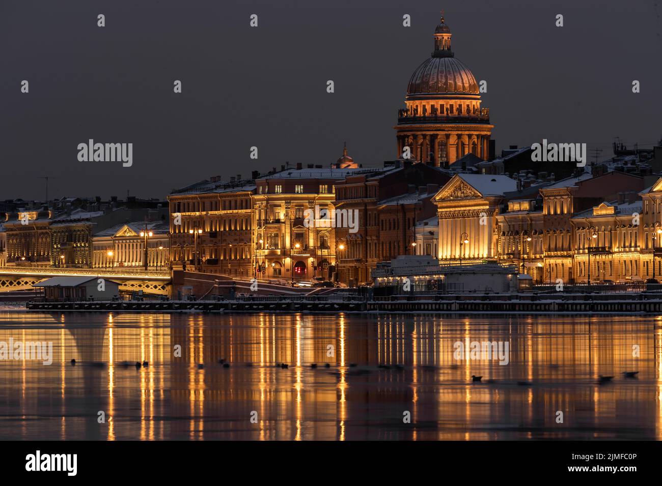 The panoramic footage of the winter night city Saint-Petersburg with picturesque reflection on water, Isaac cathedral on backgro Stock Photo
